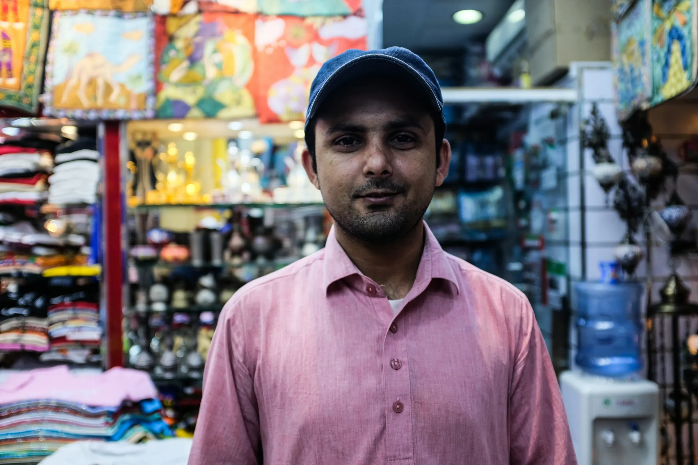 A smiling shopkeeper in his store